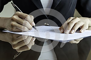 A woman signing a contract